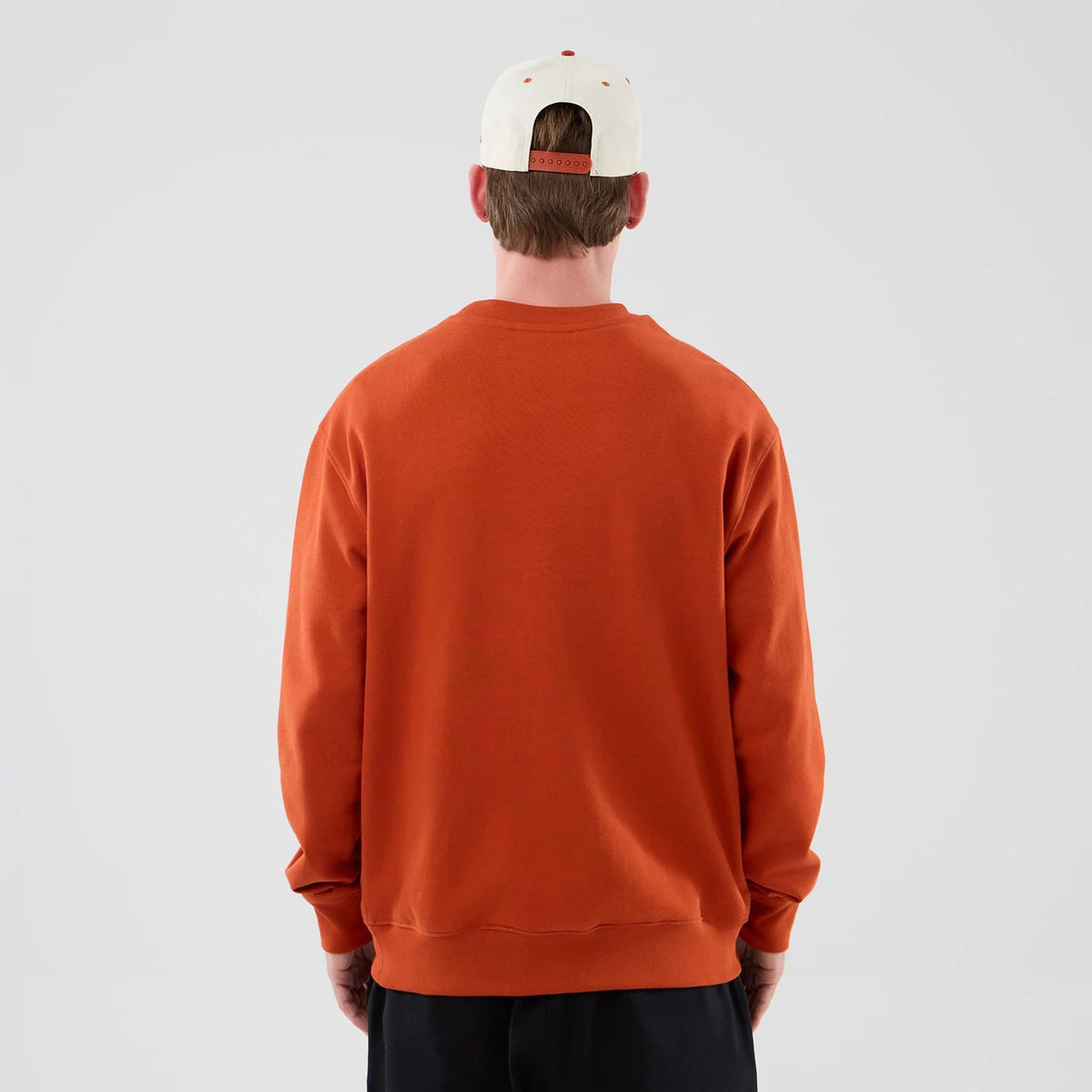 The model is wearing this MLB Arch Graphic New York Yankees Oversized Crew Neck Sweater in Orange. 2
