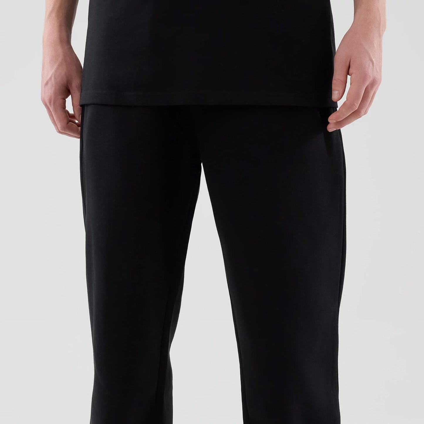 The model is wearing these New Era Tech Reflective Straight Leg Joggers in black. 3