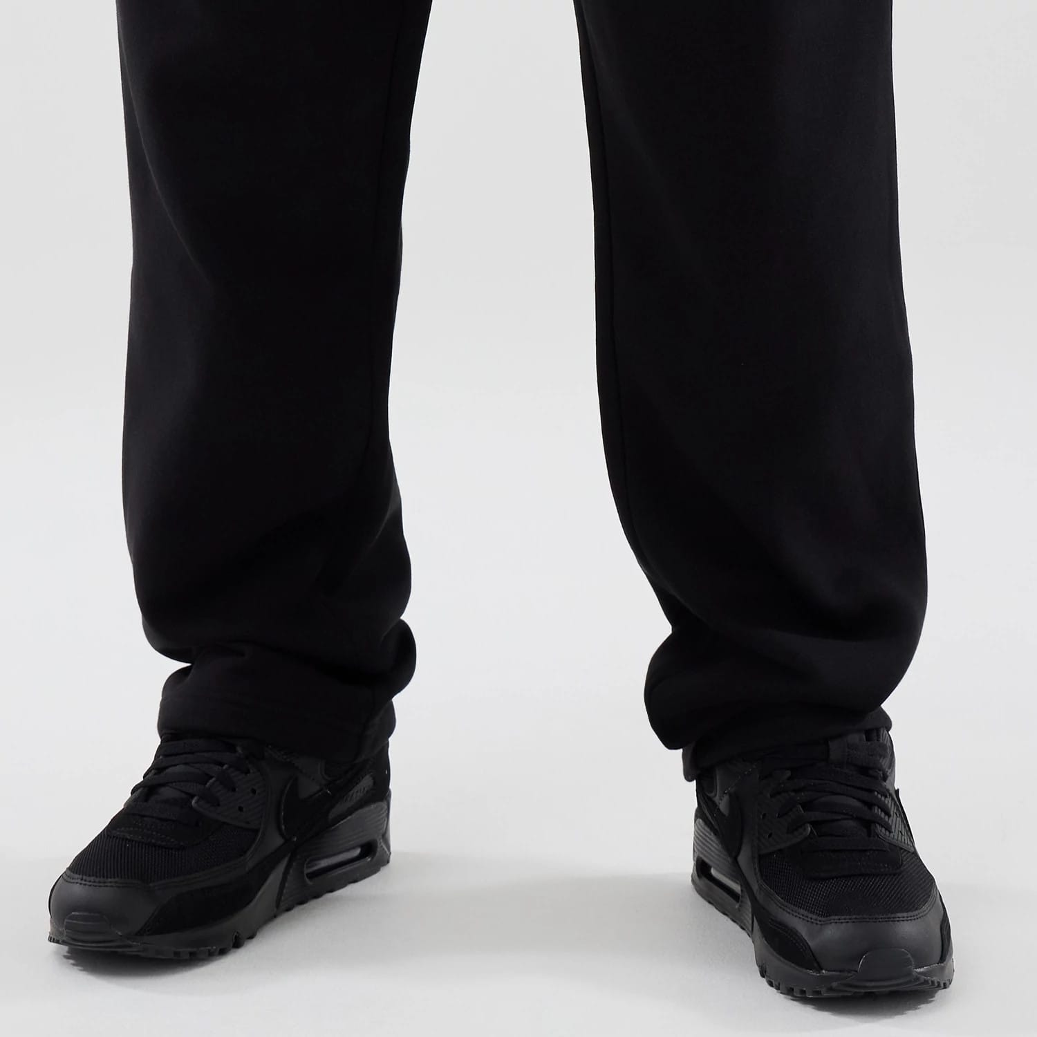 The model is wearing these New Era Tech Reflective Straight Leg Joggers in black. 6