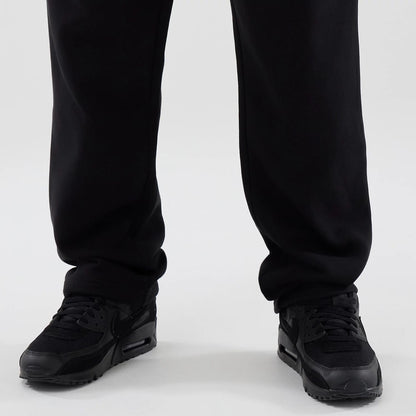 The model is wearing these New Era Tech Reflective Straight Leg Joggers in black. 6