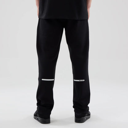 The model is wearing these New Era Tech Reflective Straight Leg Joggers in black. 2