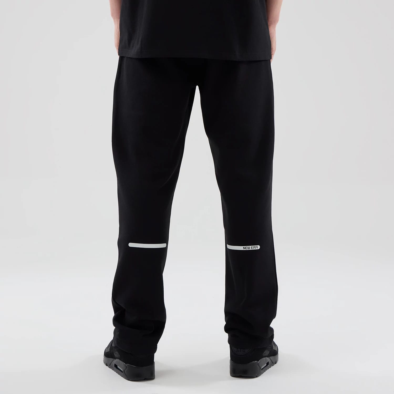 The model is wearing these New Era Tech Straight Leg Joggers in black. 2