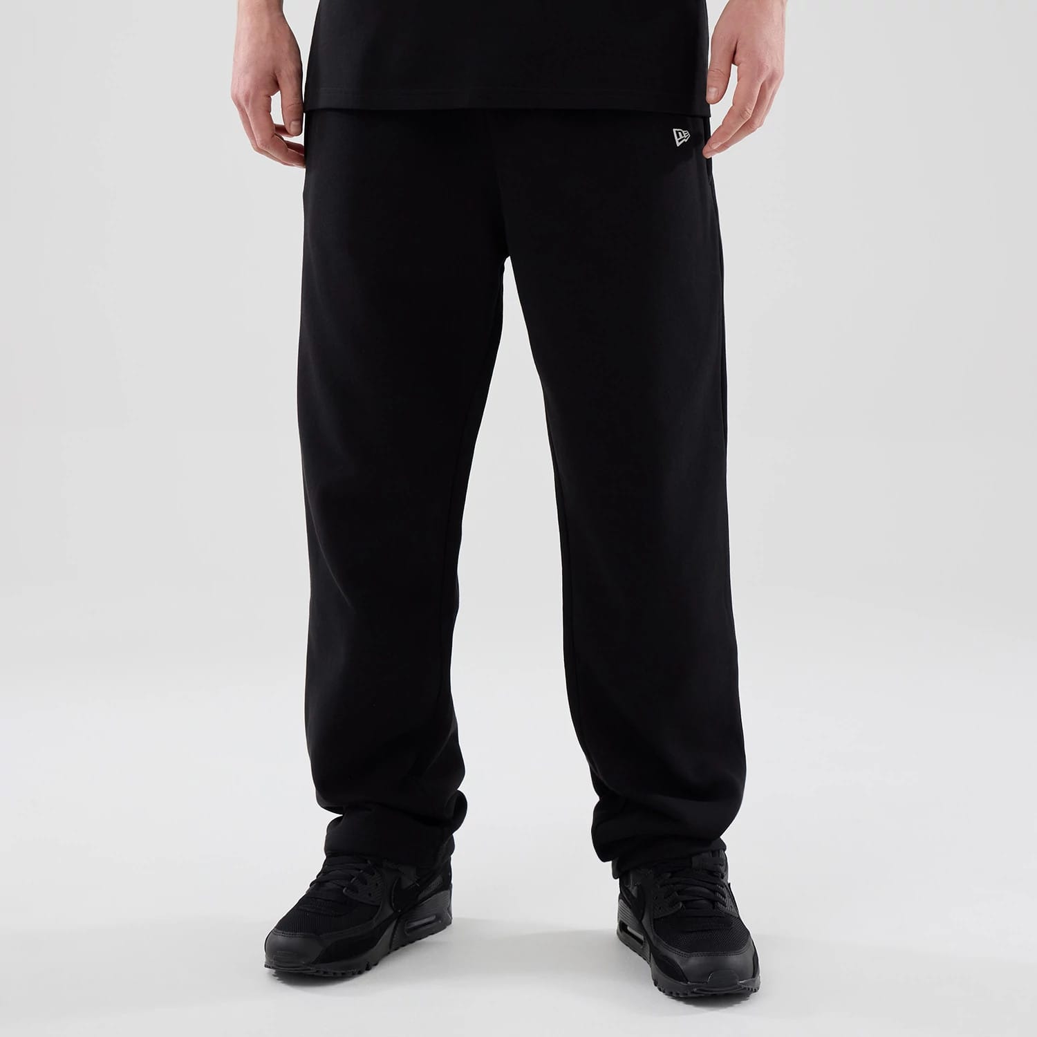 The model is wearing these New Era Tech Straight Leg Joggers in black. 1
