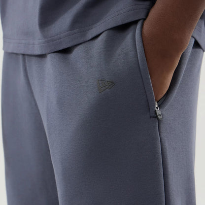 The model is wearing these New Era Tech Straight Leg Joggers in grey. 5