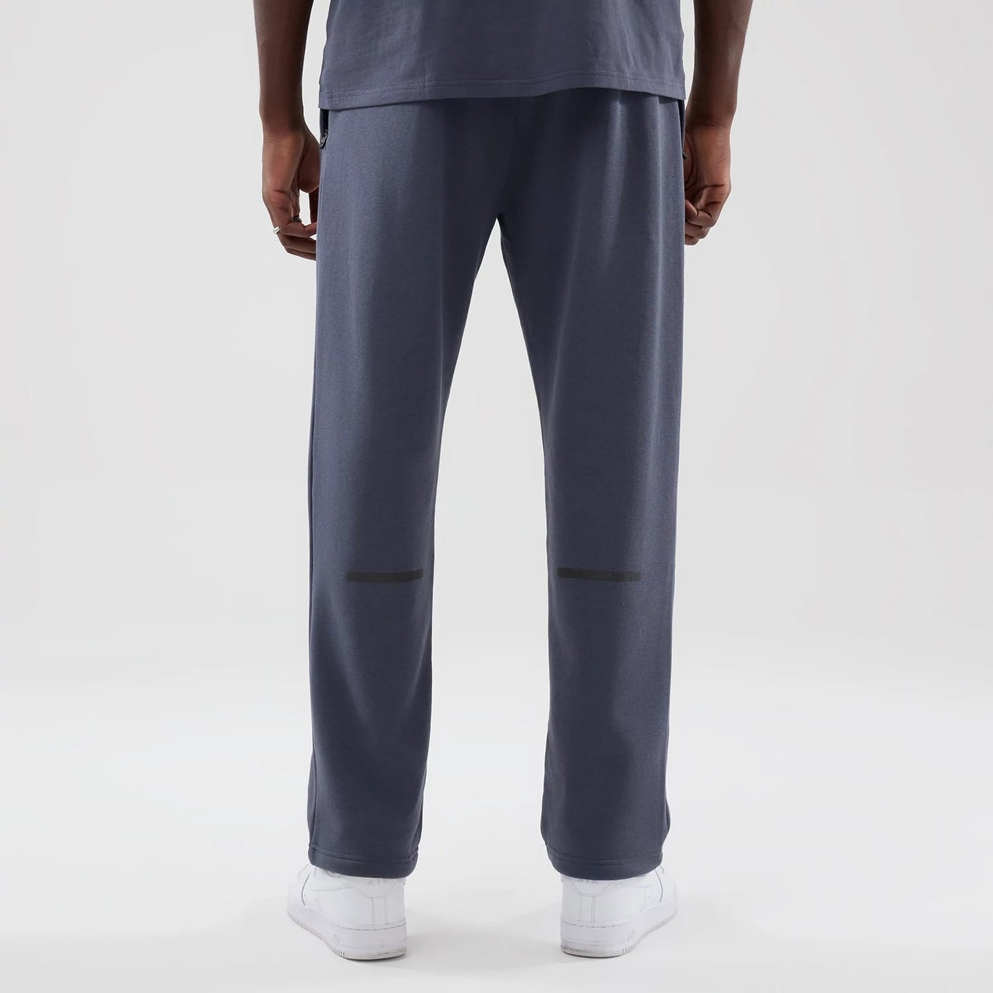 The model is wearing these New Era Tech Straight Leg Joggers in grey. 2