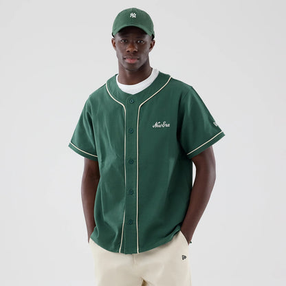 The model is wearing this New Era Baseball Jersey in dark green. 3