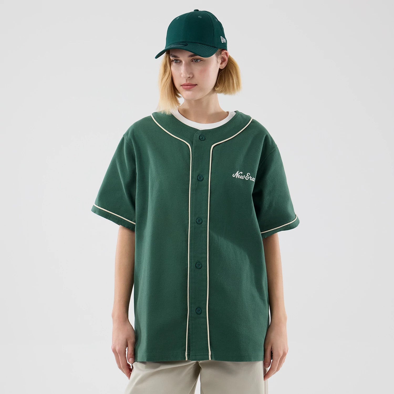 The model is wearing this New Era Baseball Jersey in dark green. 4