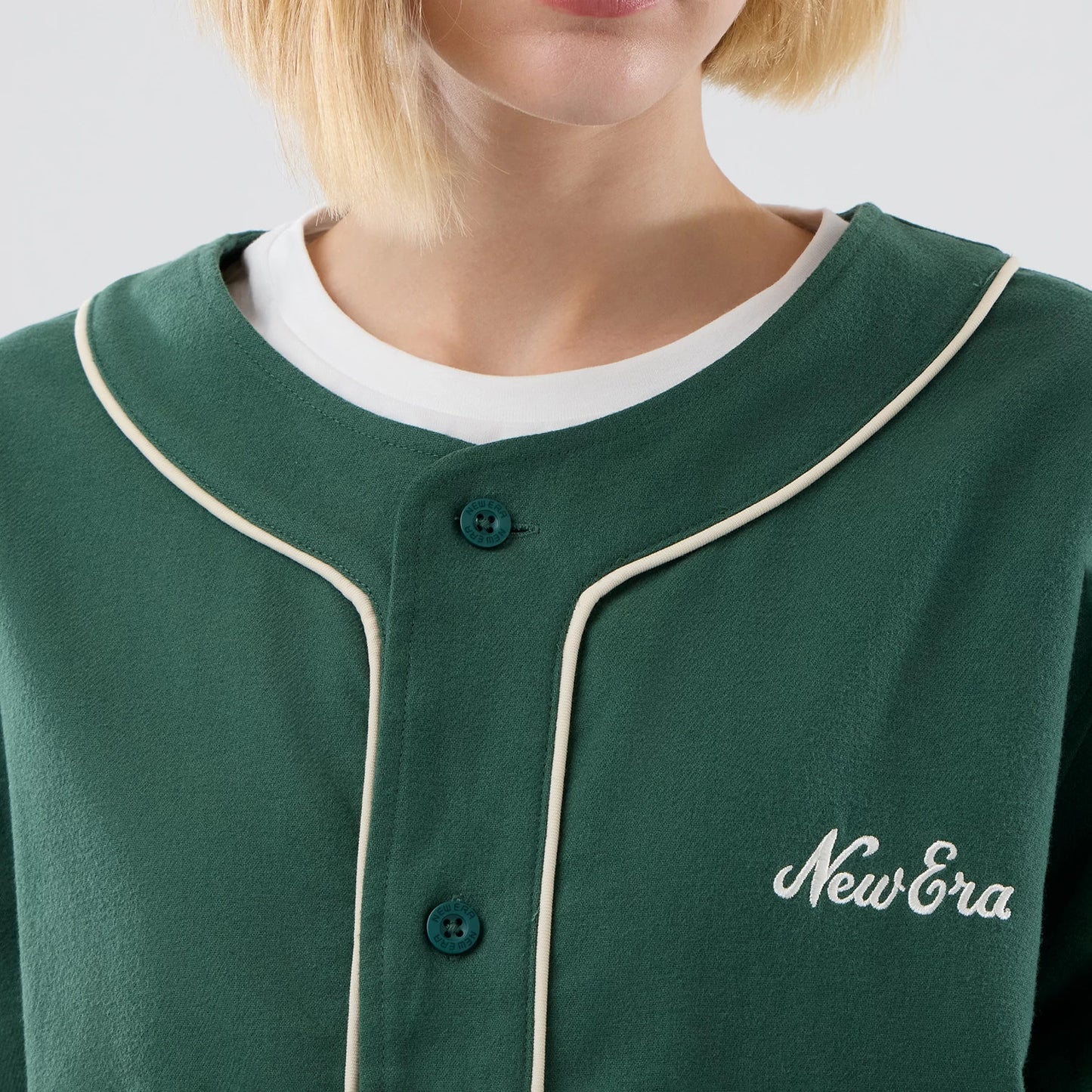 The model is wearing this New Era Baseball Jersey in dark green. 6