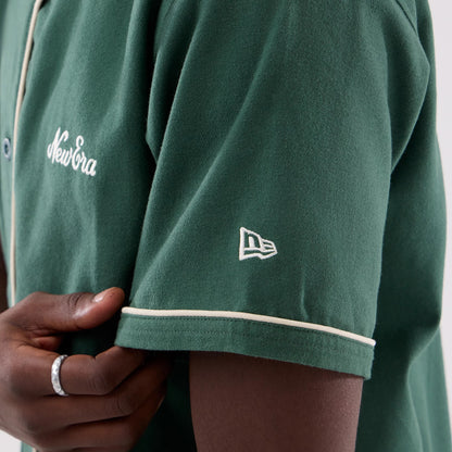 The model is wearing this New Era Baseball Jersey in dark green. 7