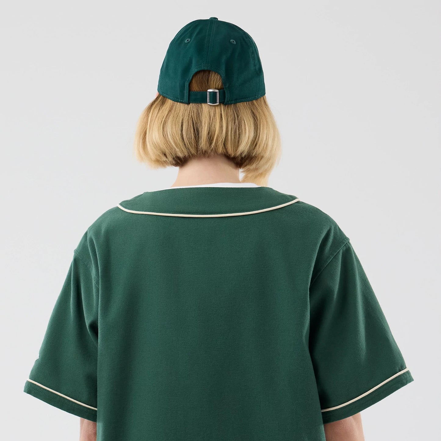 The model is wearing this New Era Baseball Jersey in dark green. 8