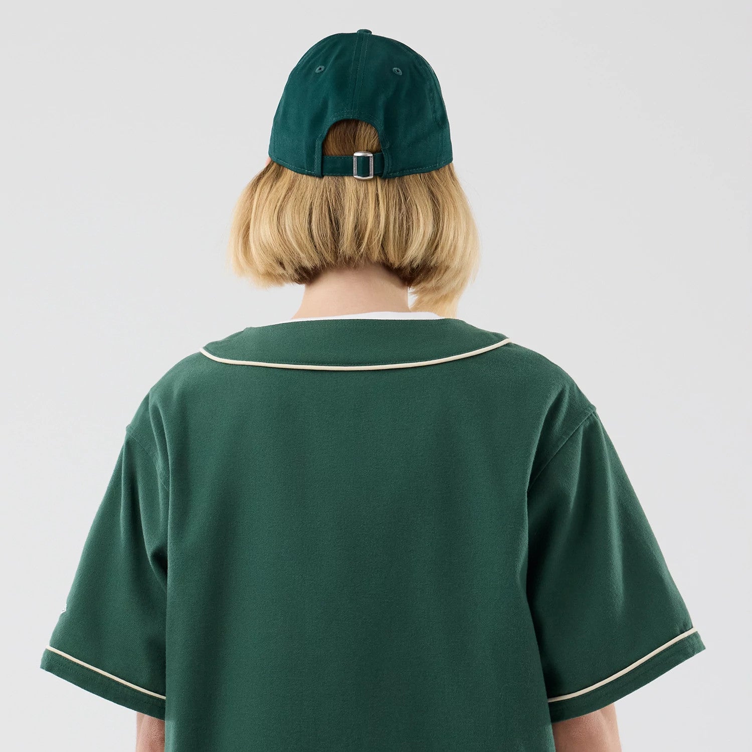 The model is wearing this New Era Baseball Jersey in dark green. 8