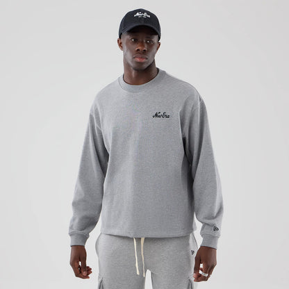 The model is wearing this New Era Oversized Crew Neck Sweater in grey. 1