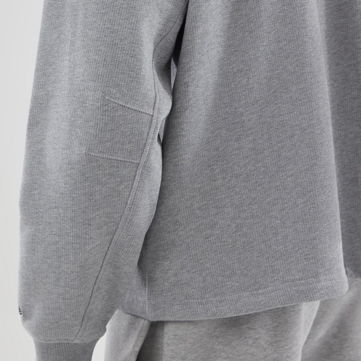 The model is wearing this New Era Oversized Crew Neck Sweater in grey. 6