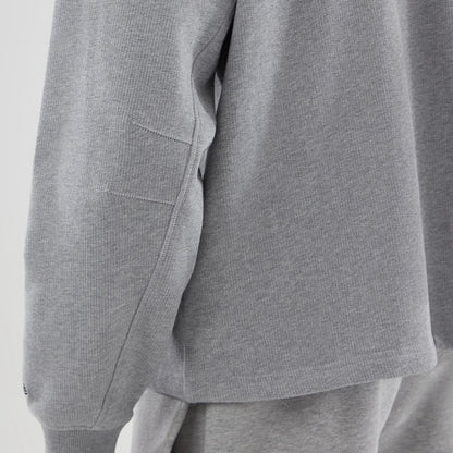The model is wearing this New Era Oversized Crew Neck Sweater in grey. 6