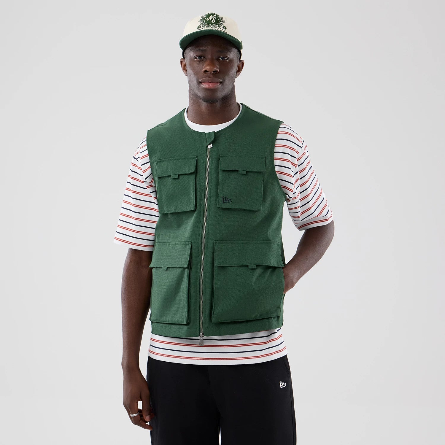 The model is wearing this New Era Utility Vest in dark green. 3