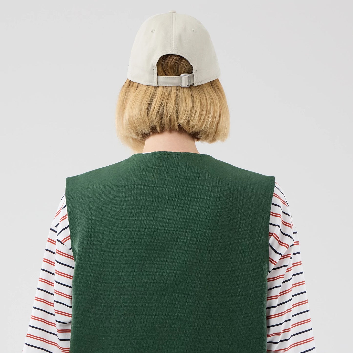 The model is wearing this New Era Utility Vest in dark green. 8