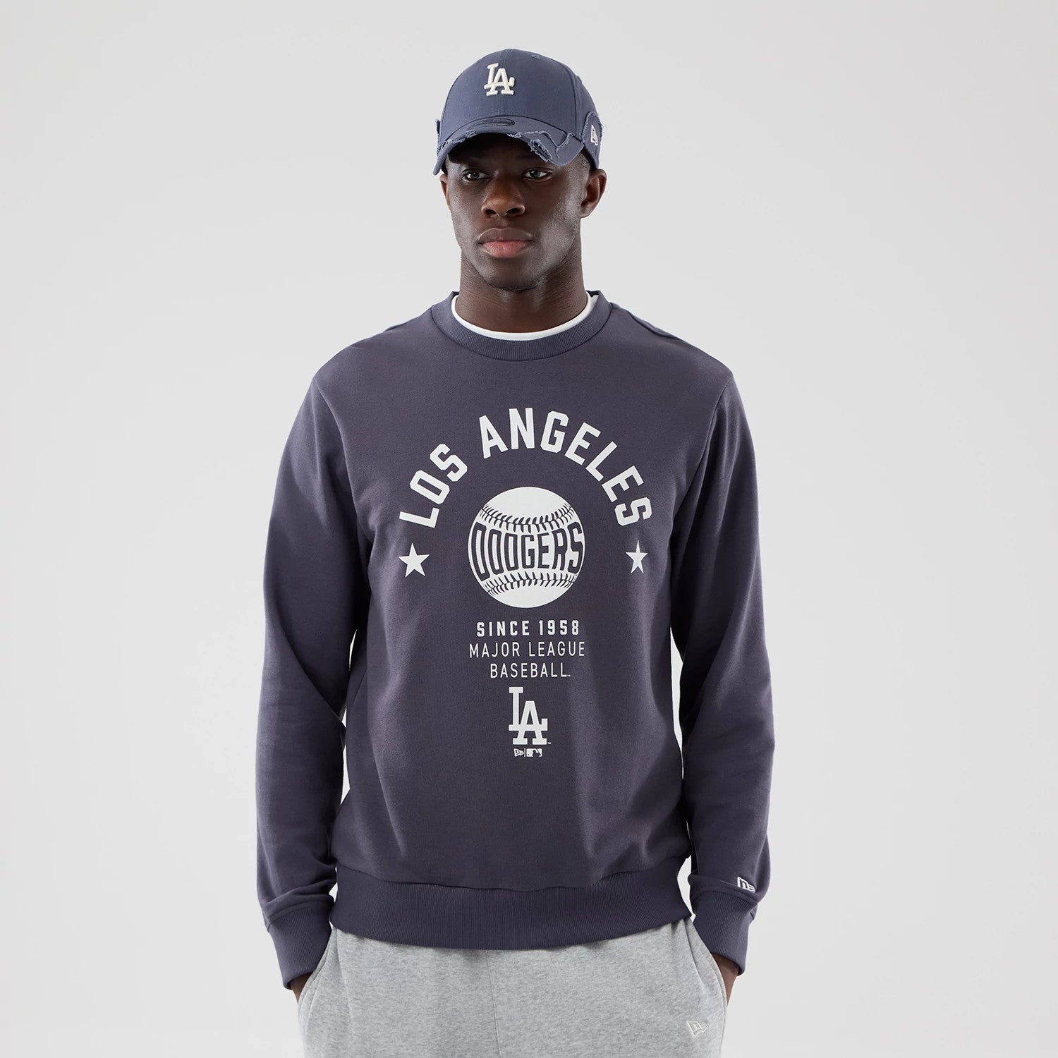 The model is wearing this MLB Graphic LA Dodgers Oversized Crew Neck Sweater in grey. 3