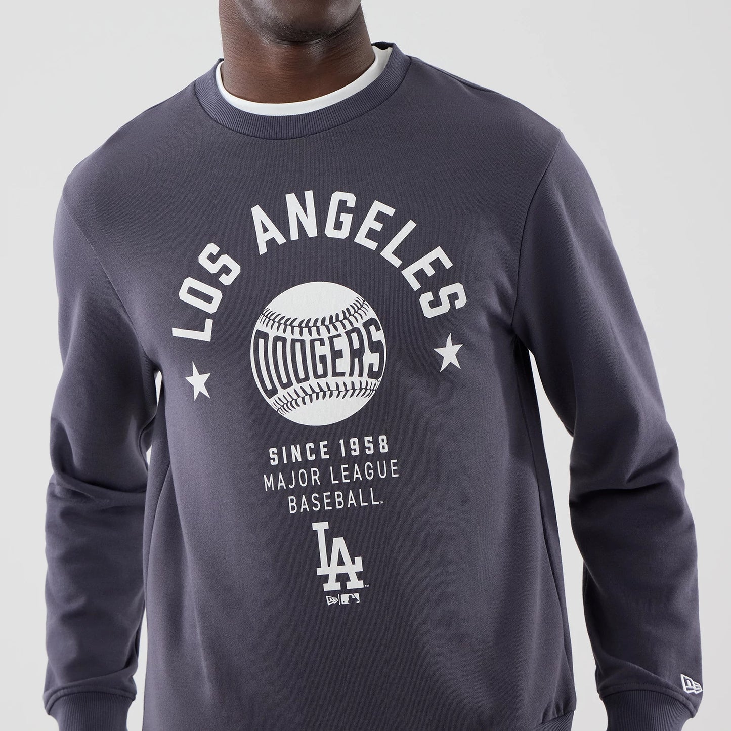 The model is wearing this MLB Graphic LA Dodgers Oversized Crew Neck Sweater in grey. 5