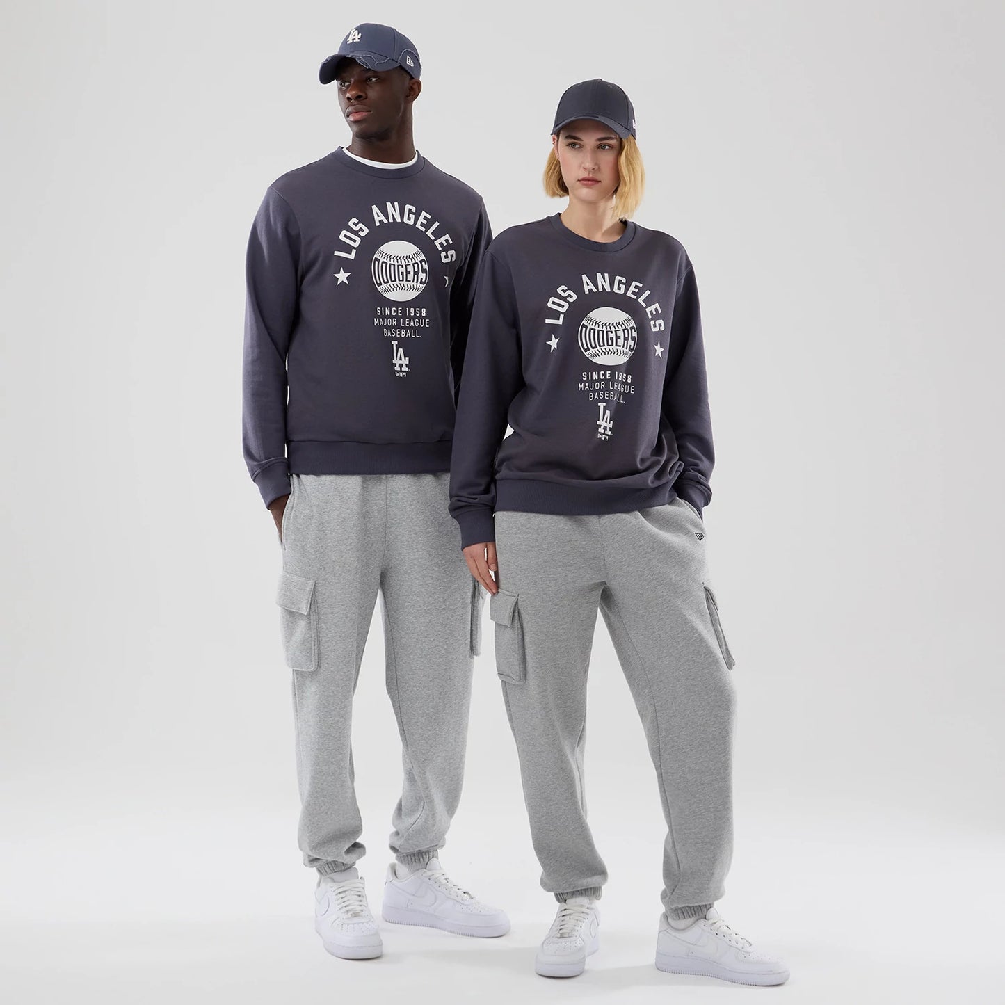 The model is wearing this MLB Graphic LA Dodgers Oversized Crew Neck Sweater in grey. 1