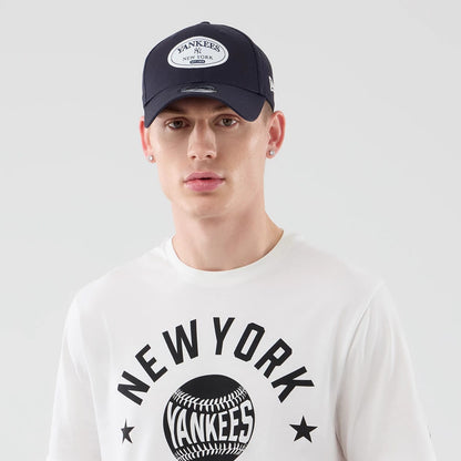 The model is wearing this MLB Graphic New York Yankees T-Shirt in white. 6