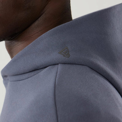 The model is wearing this New Era Tech Oversized Pullover Hoodie in grey. 5