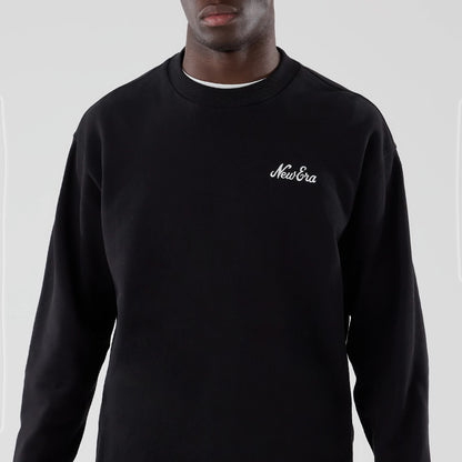 The model is wearing this New Era Oversized Crew Neck Sweater in black. 3