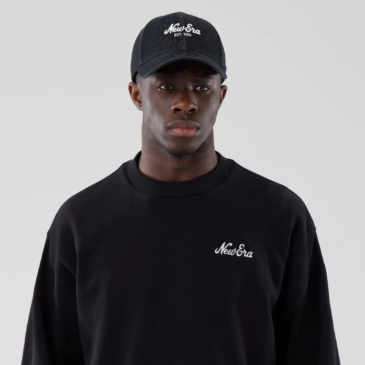 The model is wearing this New Era Oversized Crew Neck Sweater in black. 6