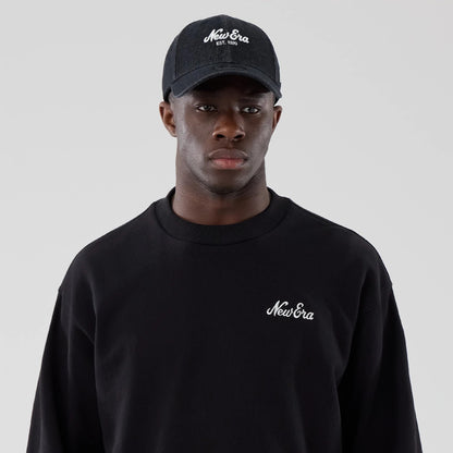 The model is wearing this New Era Oversized Crew Neck Sweater in black. 6