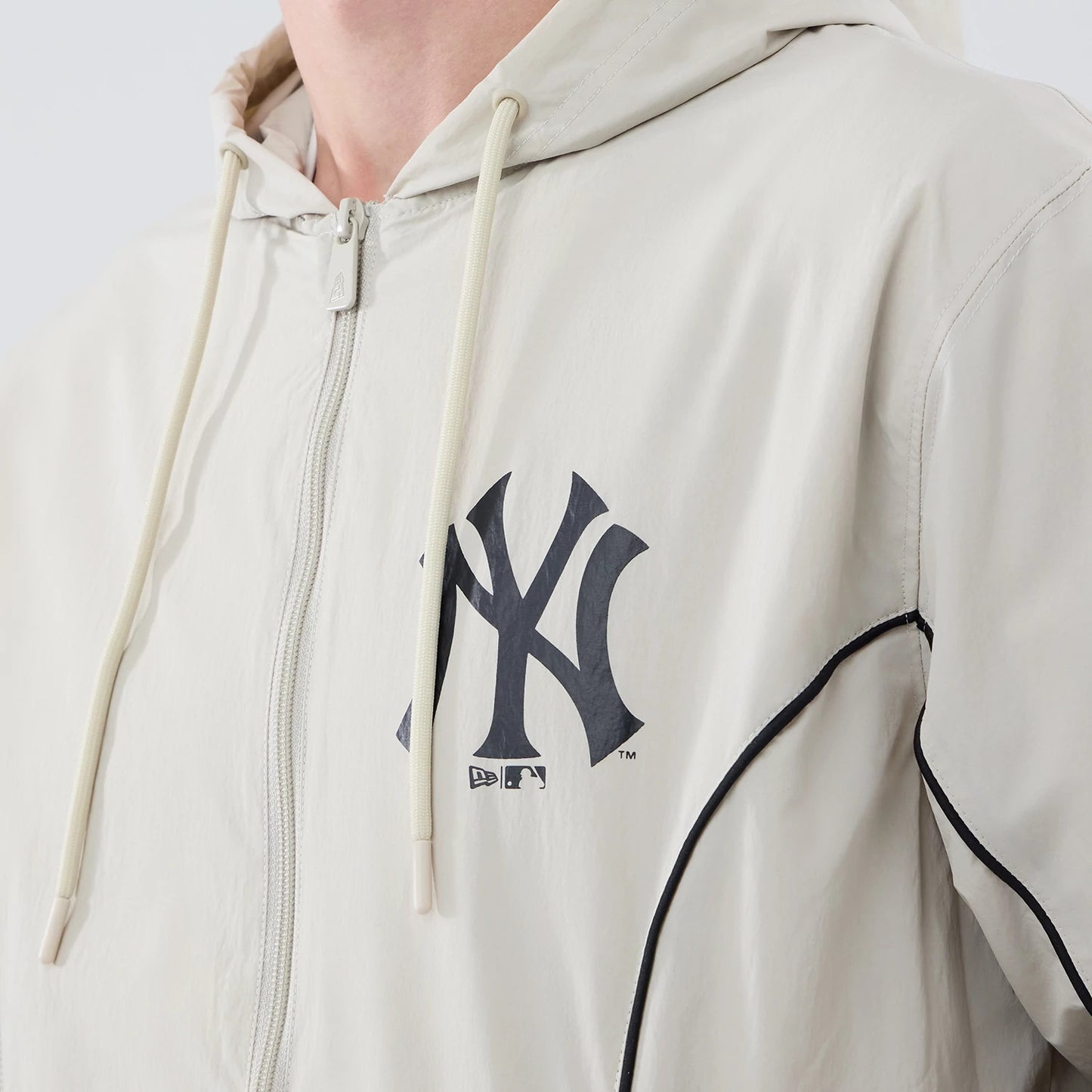 The model is wearing this MLB Piping New York Yankees Jacket in cream. 4