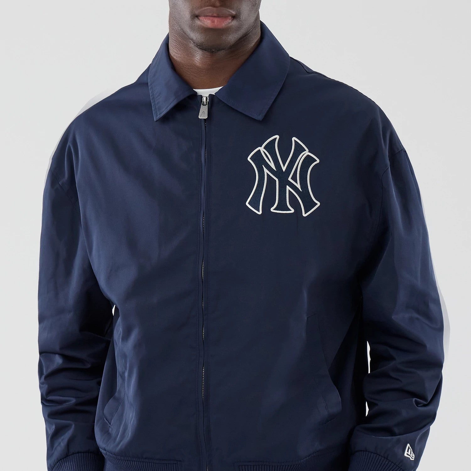 The model is wearing this MLB Collared New York Yankees Jacket in navy. 3