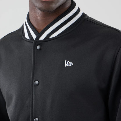The model is wearing this New Era Jersey Bomber Jacket in black. 4