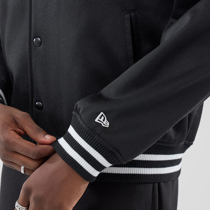 The model is wearing this New Era Jersey Bomber Jacket in black. 5
