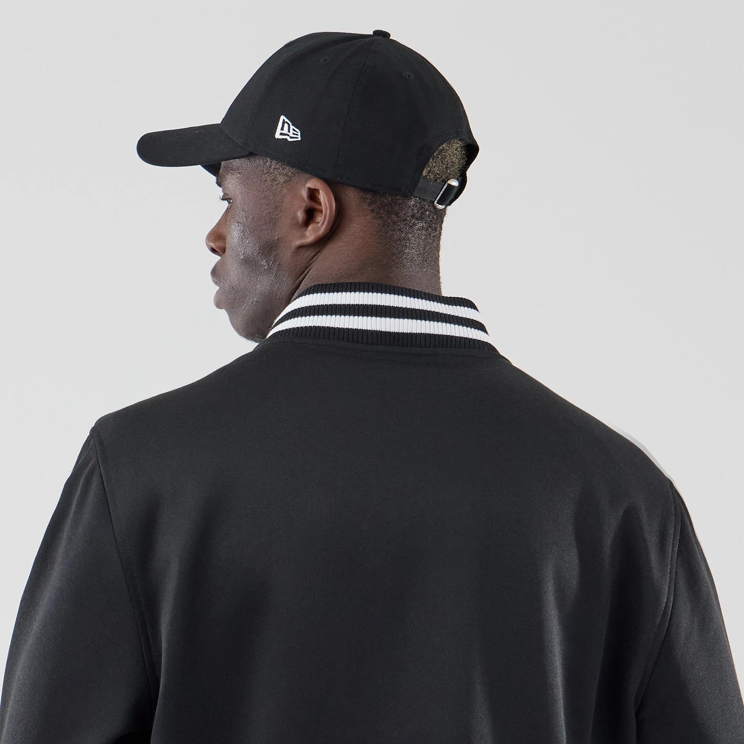 The model is wearing this New Era Jersey Bomber Jacket in black. 6
