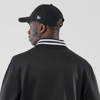 The model is wearing this New Era Jersey Bomber Jacket in black. 6