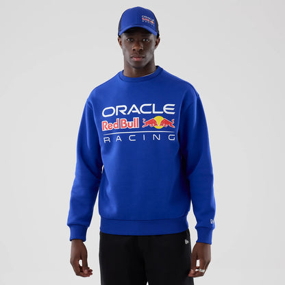 The model is wearing this Red Bull Racing Oversized Crew Neck Sweater in blue. 1