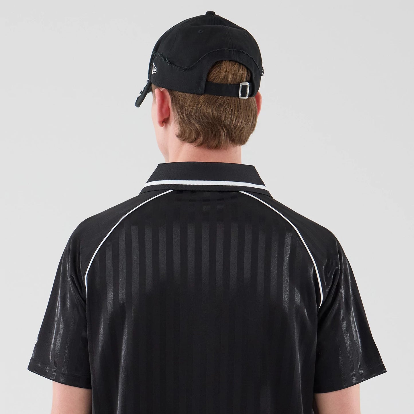 The model is wearing this New Era Football Jersey T-Shirt in black. 7
