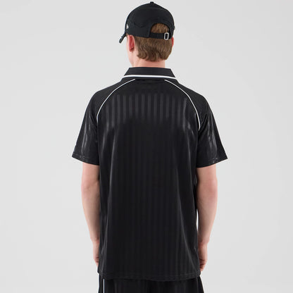 The model is wearing this New Era Football Jersey T-Shirt in black. 2