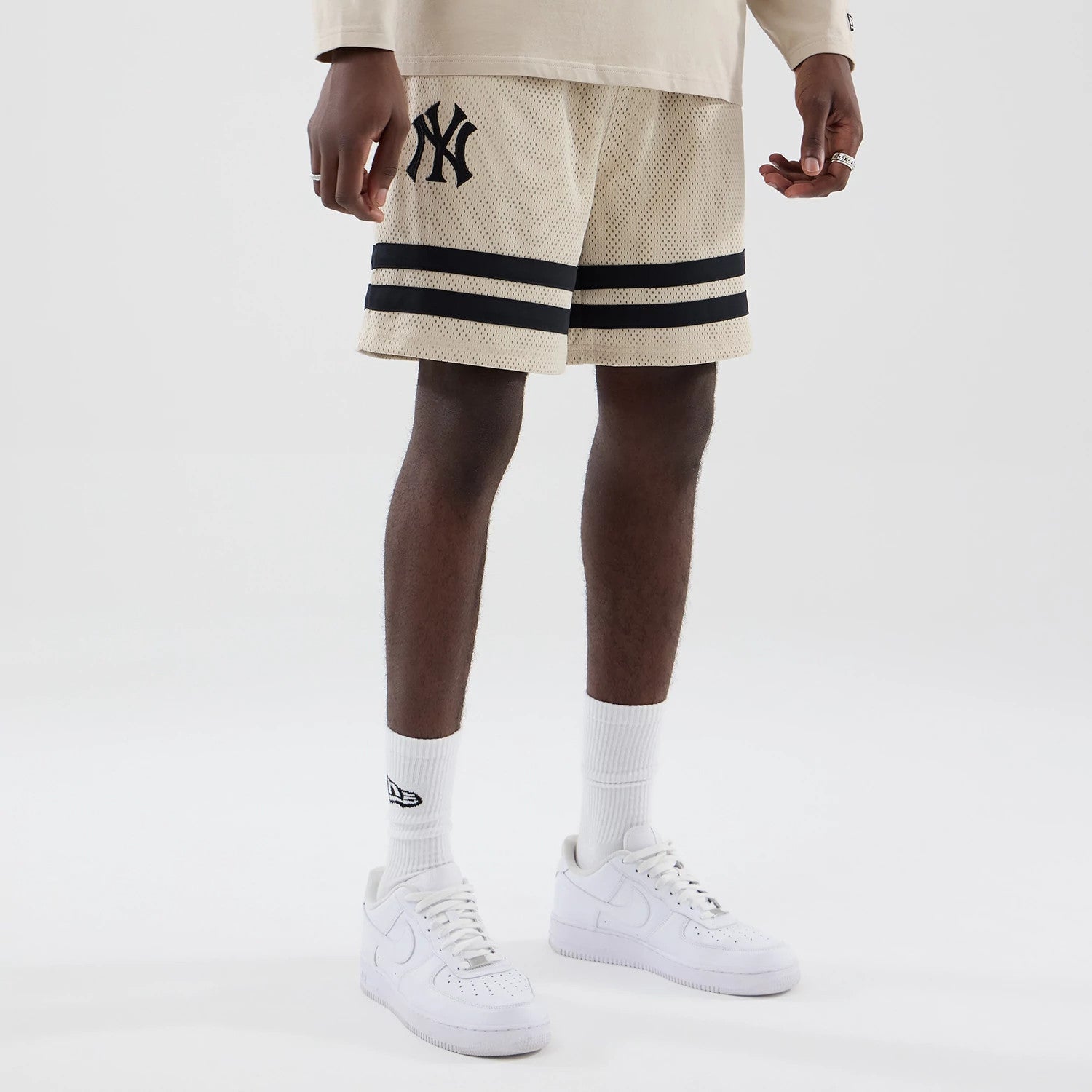 The model is wearing these MLB New York Yankees Oversized Mesh Shorts in light beige. 7