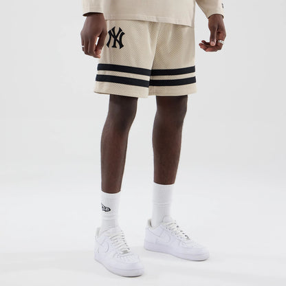 The model is wearing these MLB New York Yankees Oversized Mesh Shorts in light beige. 7