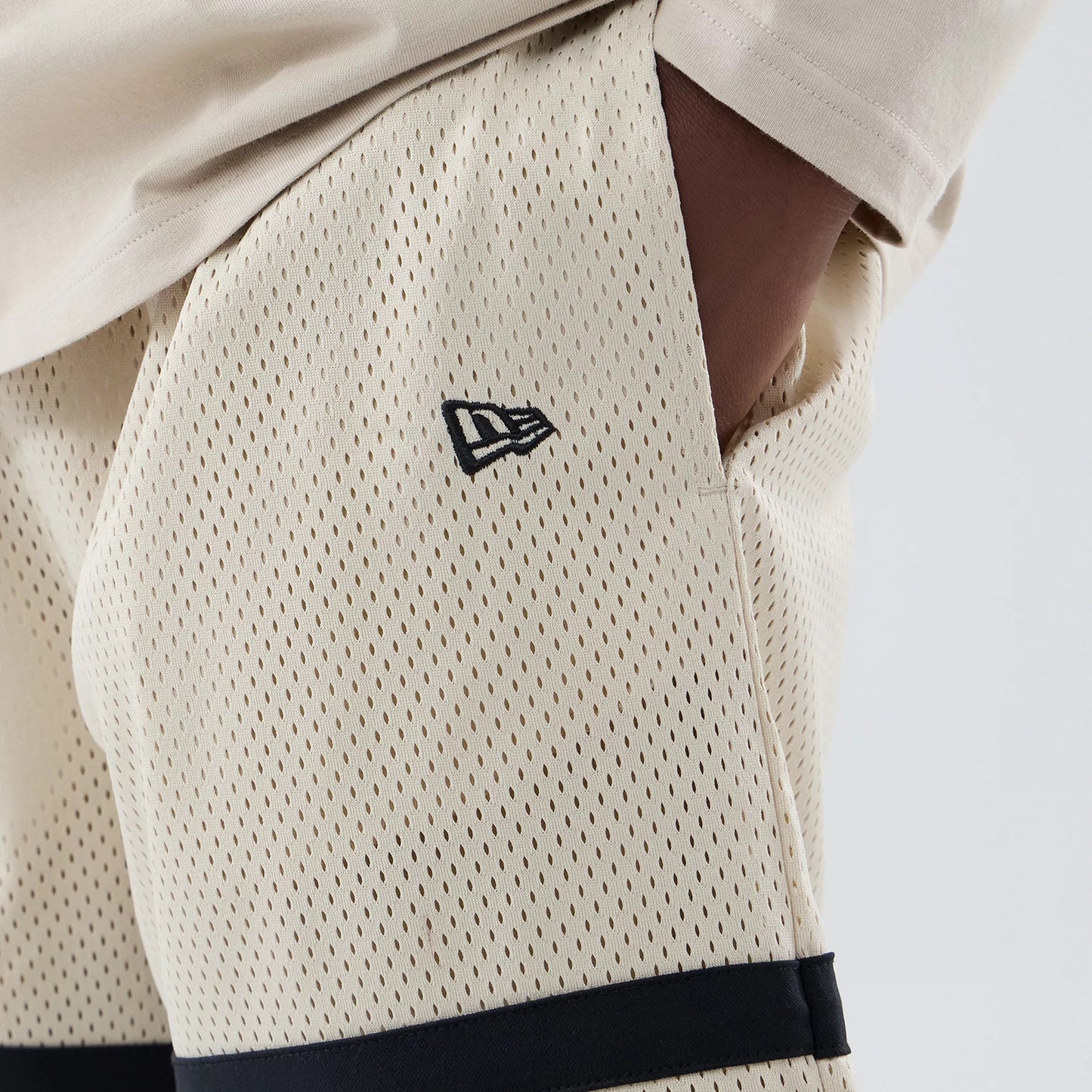 The model is wearing these MLB New York Yankees Oversized Mesh Shorts in light beige. 4