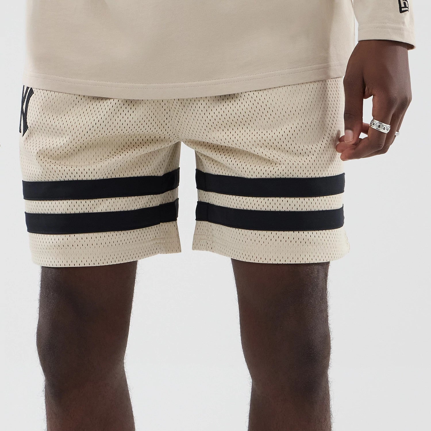 The model is wearing these MLB New York Yankees Oversized Mesh Shorts in light beige. 5