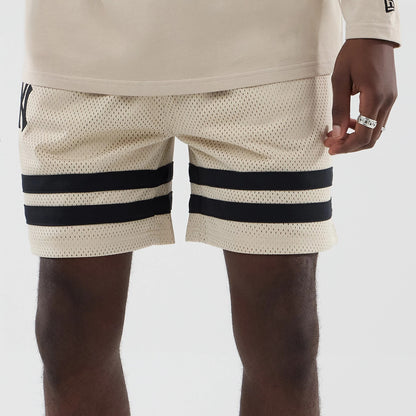 The model is wearing these MLB New York Yankees Oversized Mesh Shorts in light beige. 5
