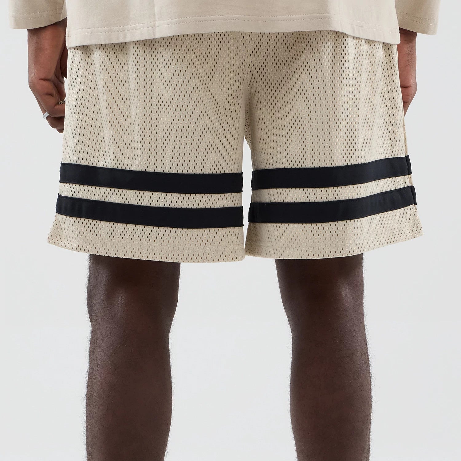 The model is wearing these MLB New York Yankees Oversized Mesh Shorts in light beige. 6