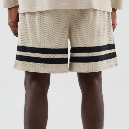 The model is wearing these MLB New York Yankees Oversized Mesh Shorts in light beige. 6