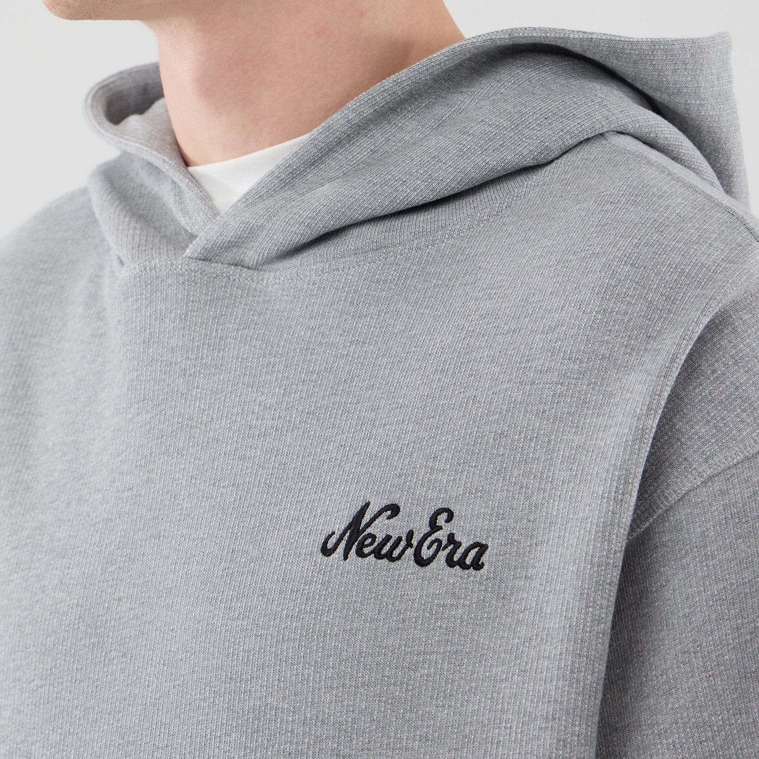 The model is wearing this New Era Open Hem Pullover Hoodie in grey. 4