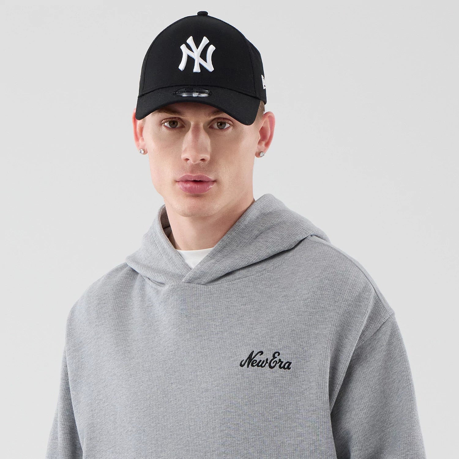 The model is wearing this New Era Open Hem Pullover Hoodie in grey. 6