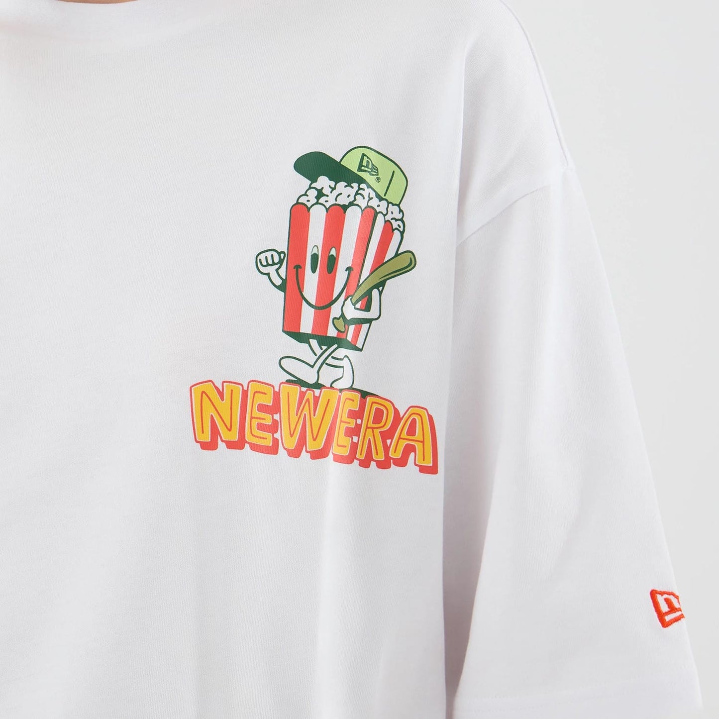 The model is wearing this New Era Food Graphic Oversized T-Shirt in white. 6