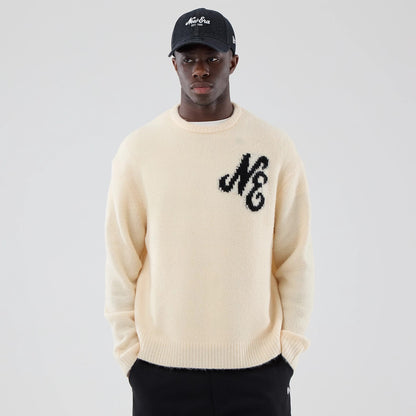 The model is wearing this New Era Knit Knitted Sweater in cream. 3