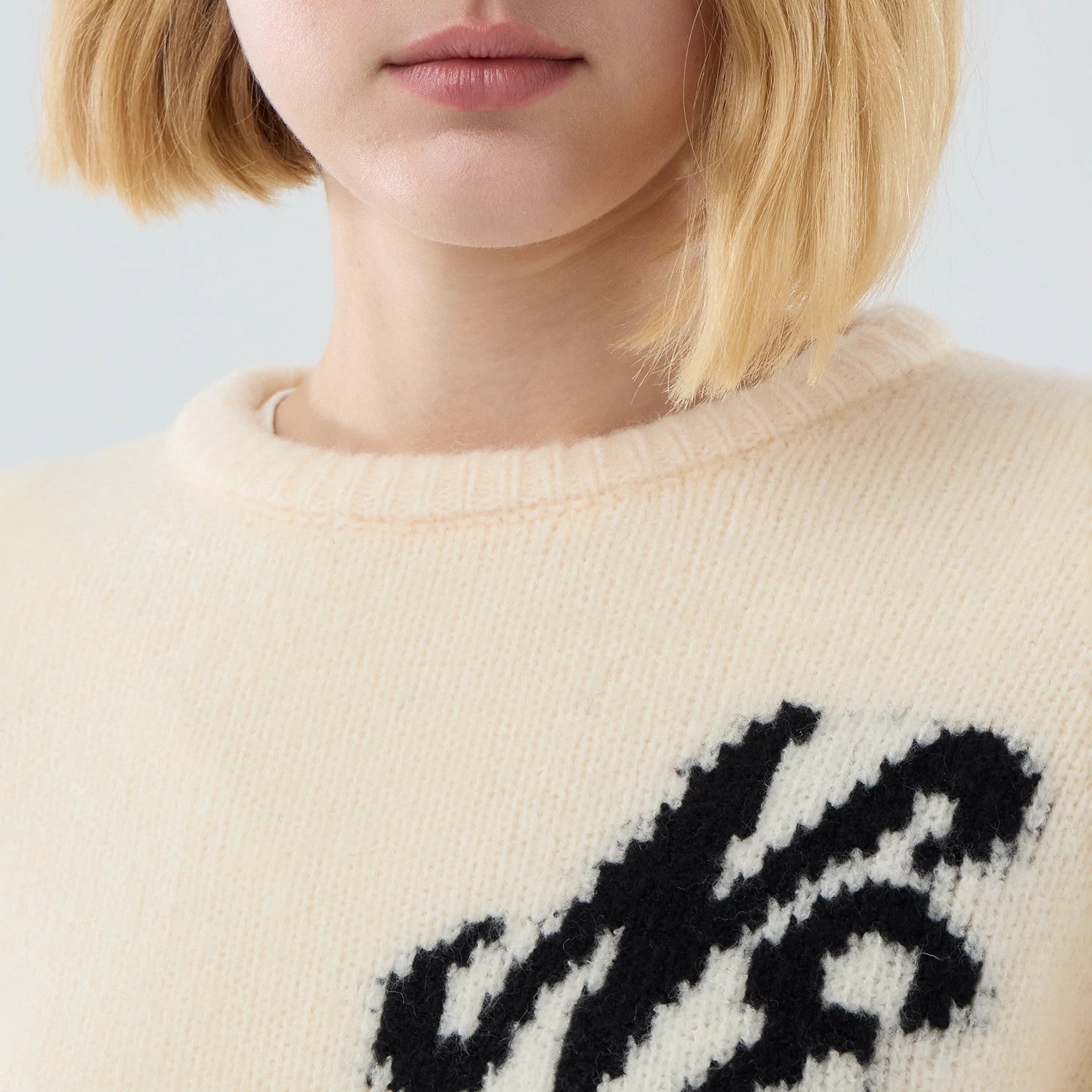 The model is wearing this New Era Knit Knitted Sweater in cream. 6