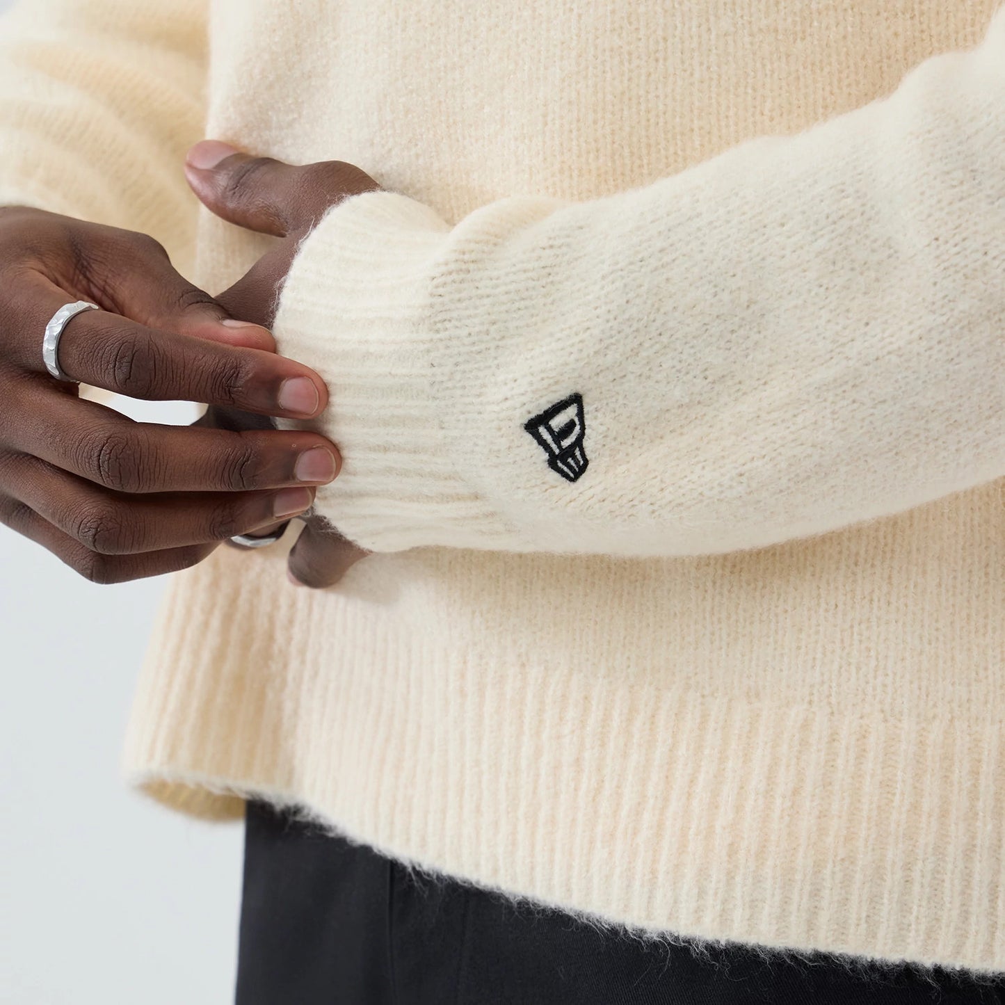 The model is wearing this New Era Knit Knitted Sweater in cream. 7